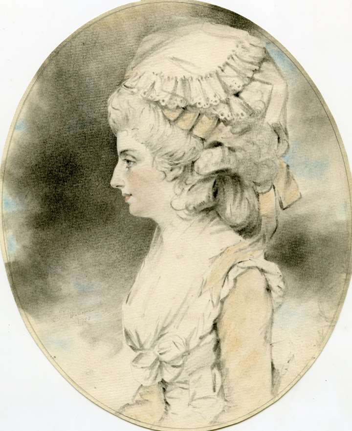 A portrait of a young girl in profile in a mob cap